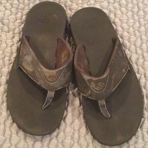 Brown reef sandals.  Worn and salt wear on them.